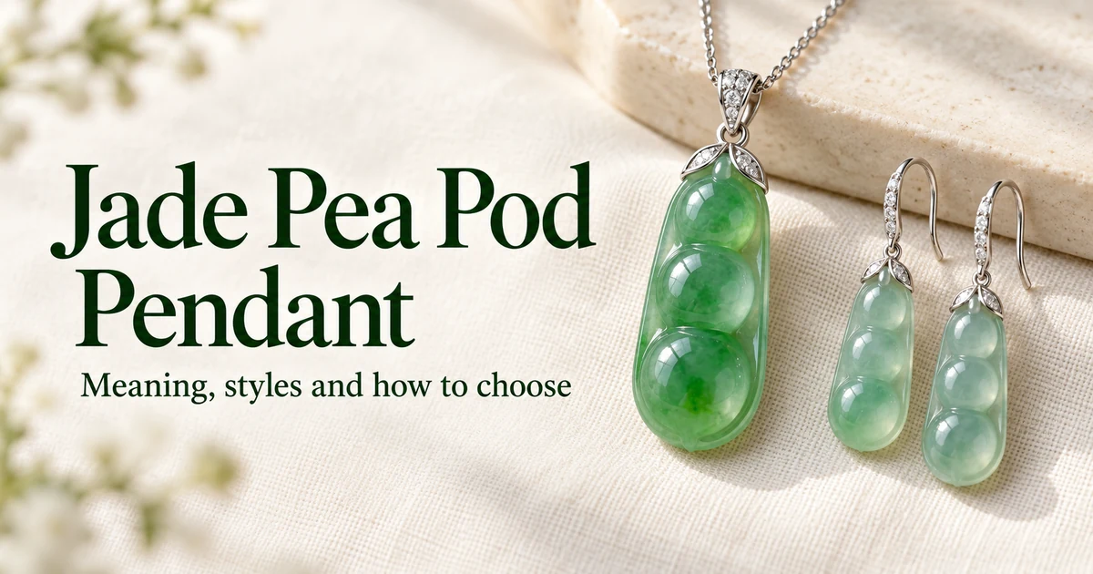 A vivid green high icy jadeite pea pod pendant with a white gold cap on a fine white gold chain, lying on ivory linen beside a pair of pale icy pea pod drop earrings, in soft daylight
