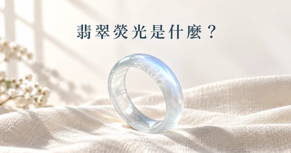 米白色亞麻布上一隻無色冰種翡翠手鐲,窗邊柔光下弧面浮起淡淡的藍白色熒光,配標題「翡翠熒光是什麼?」