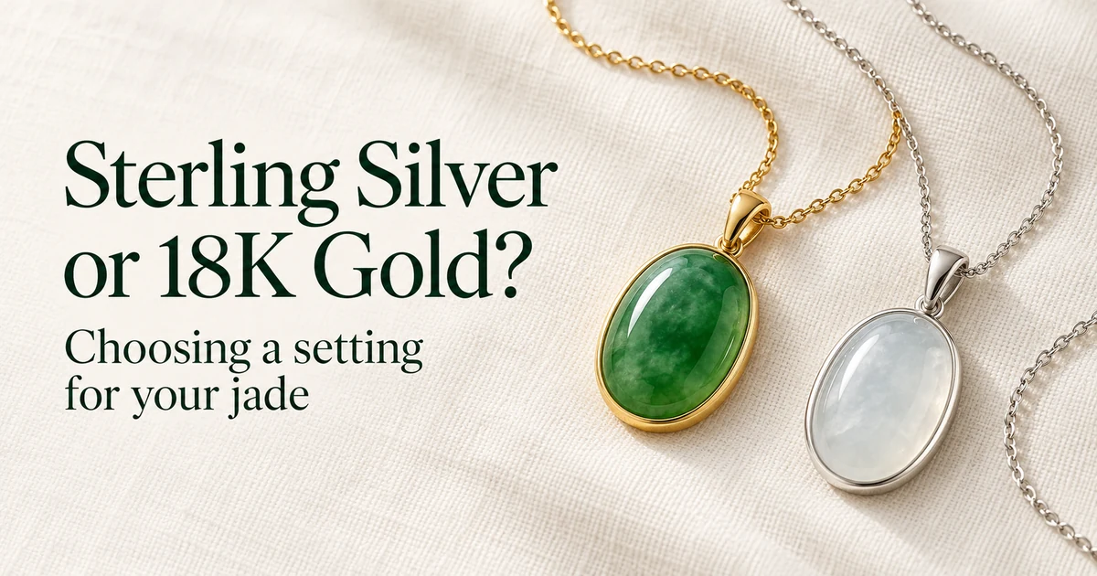 An oval green jadeite cabochon pendant in a yellow gold bezel on a gold chain and an oval icy, nearly colorless jadeite cabochon pendant in a silver bezel on a silver chain, on ivory linen